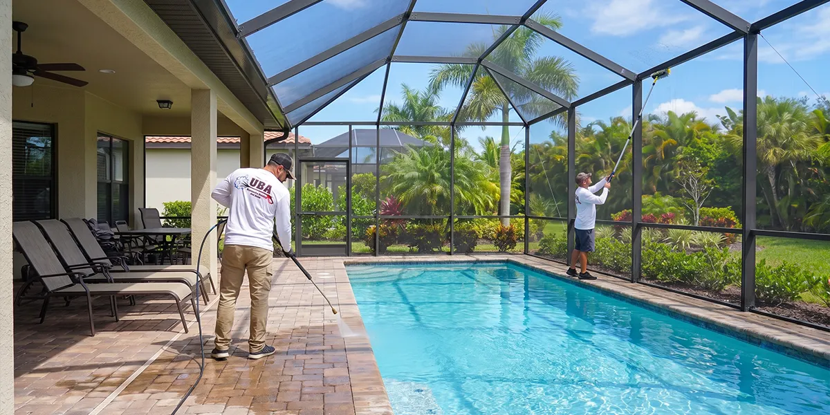 UBA crew cleaning a Florida pool deck, cage, and lanai together in one sequenced visit