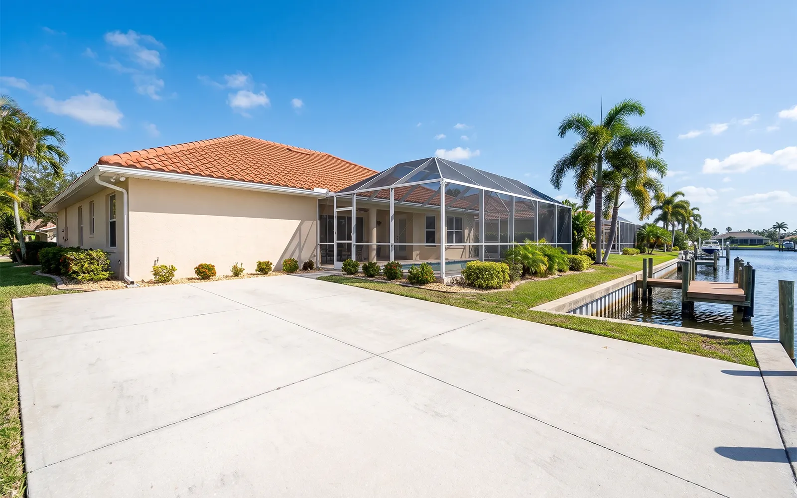 Pressure washing Port Charlotte home with a clean roof, washed stucco and clean driveway