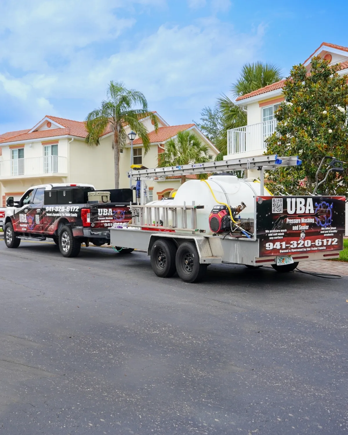 UBA Pressure Washing branded truck and custom aluminum equipment trailer parked in front of a Sarasota tile-roof home