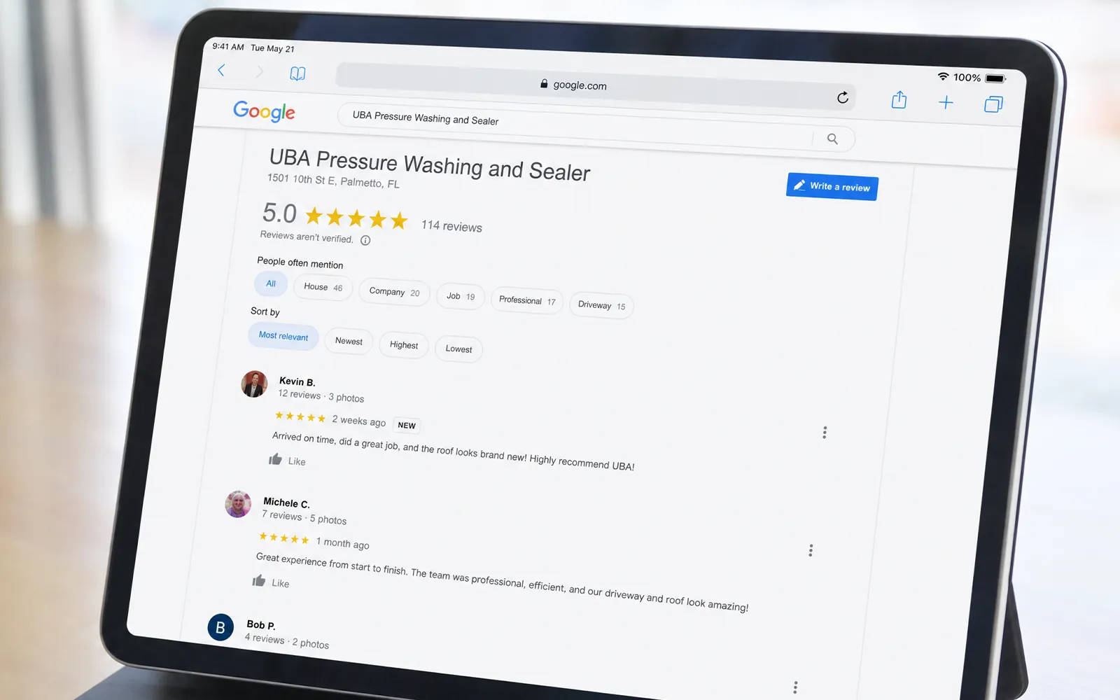 iPad displaying UBA Pressure Washing and Sealer's Google Business Profile showing a 5.0 star rating and verified homeowner reviews from Sarasota and Manatee counties