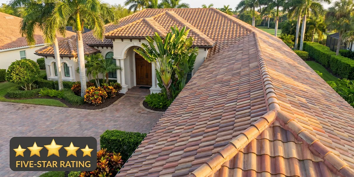 Aerial view of a clean Florida clay tile roof in a Sarasota neighborhood with a five-star rating badge overlay, representing UBA's top-rated pressure washing and sealing results