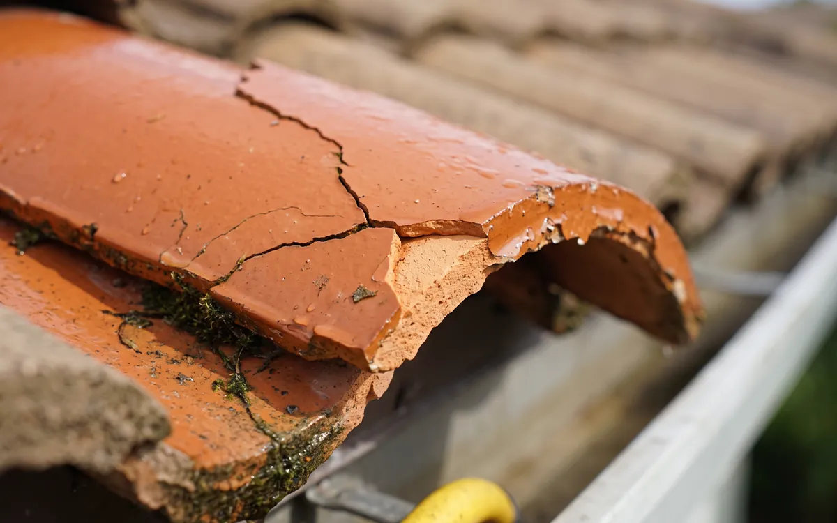 Cracked Florida tile edge from high-pressure washing damage